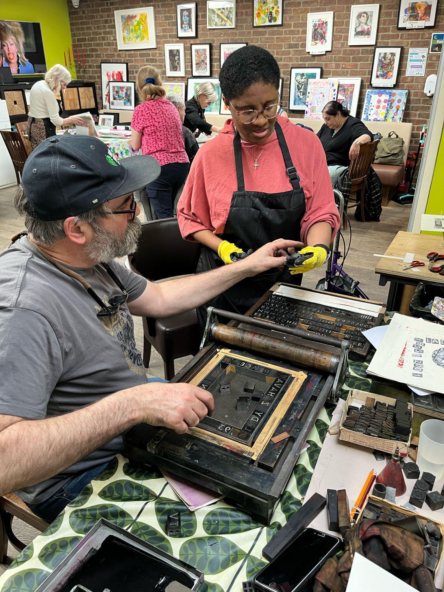 Print maker showing how print machinery works