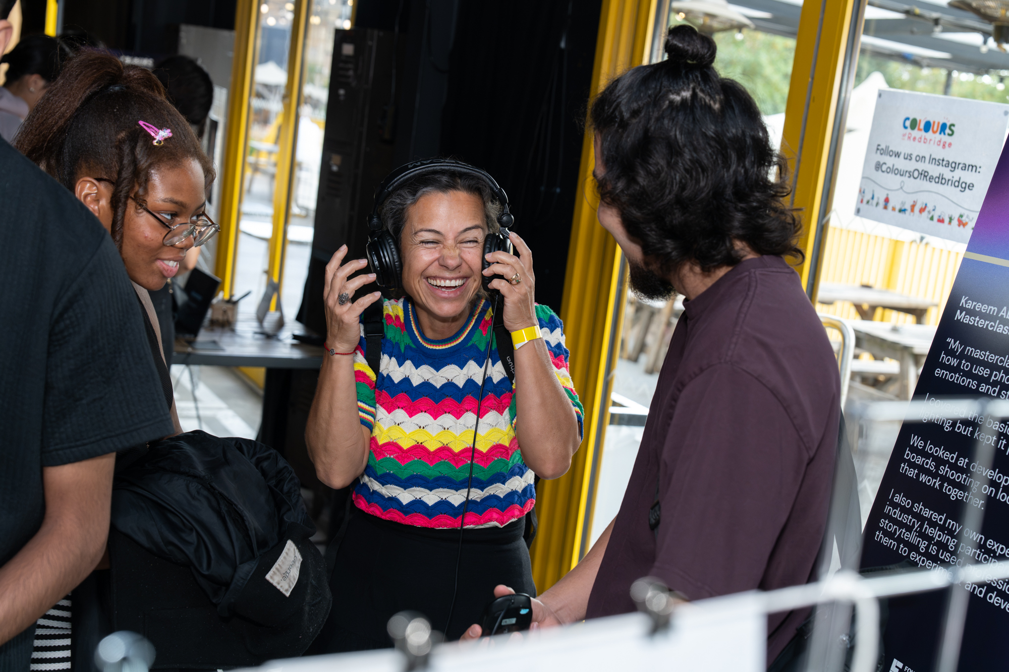 People wearing headphones and laughing